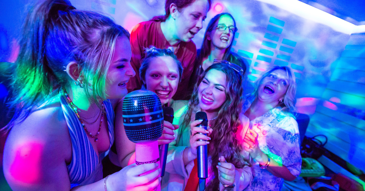 group of women singing in the karaoke pod at tenpin